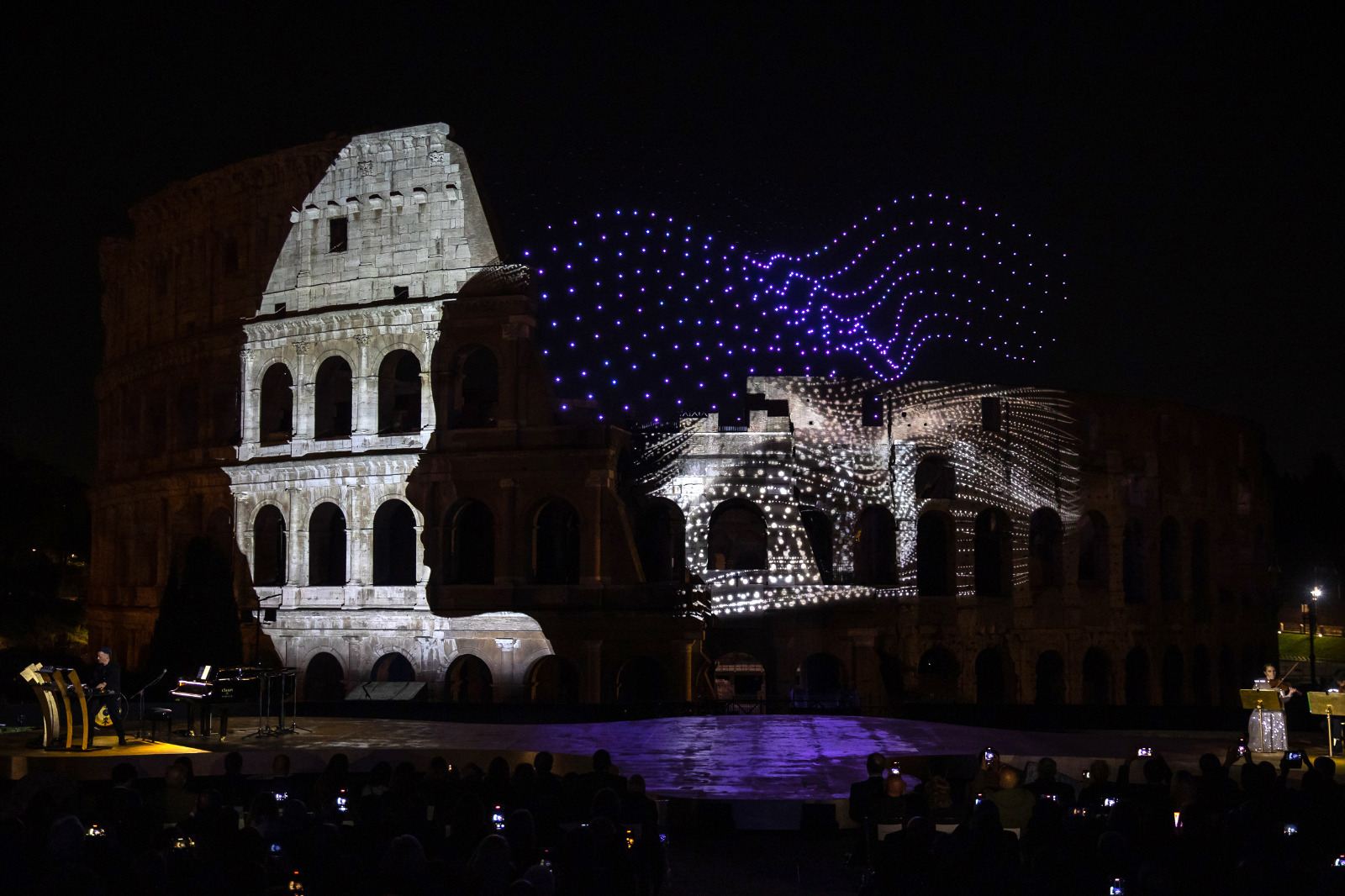 Malika Ayane and Dardust performing at the Colosseum with drone light show
