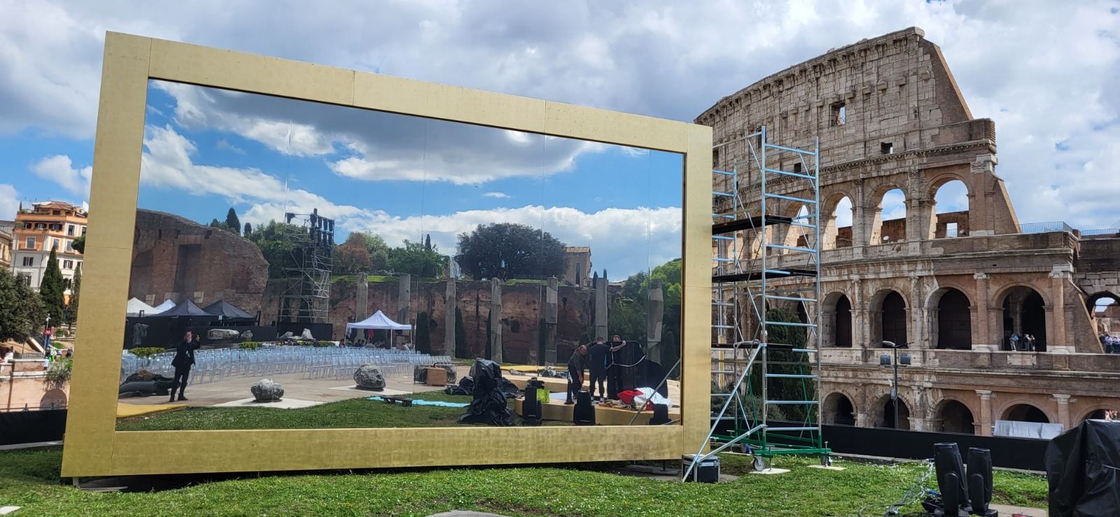 Stage setup during the day with golden frame screen and Colosseum